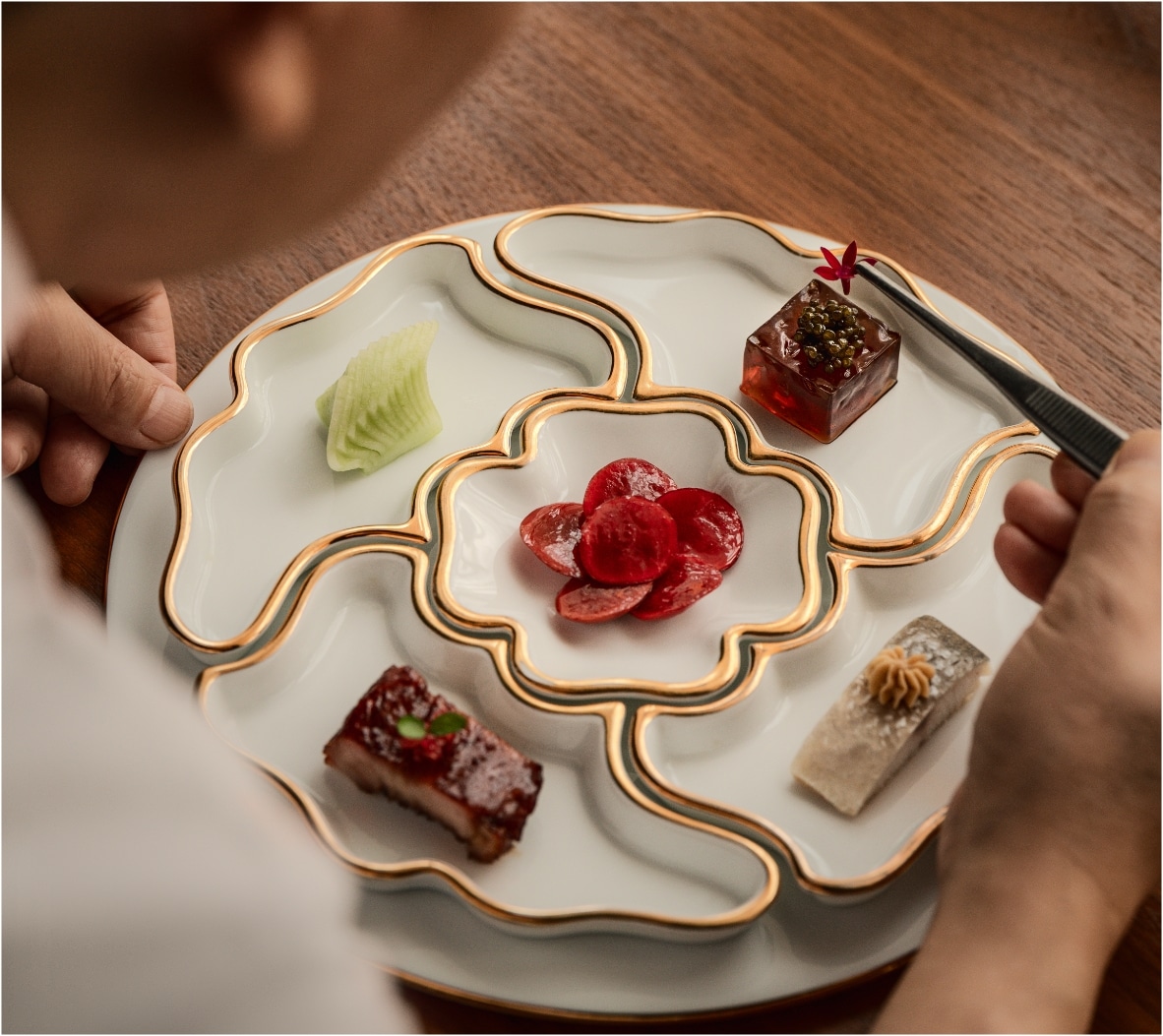 Artisinal appetizer platter on a porcelain plate with gold trimming, at Mandarin Oriental Residences and Resort Kanai.